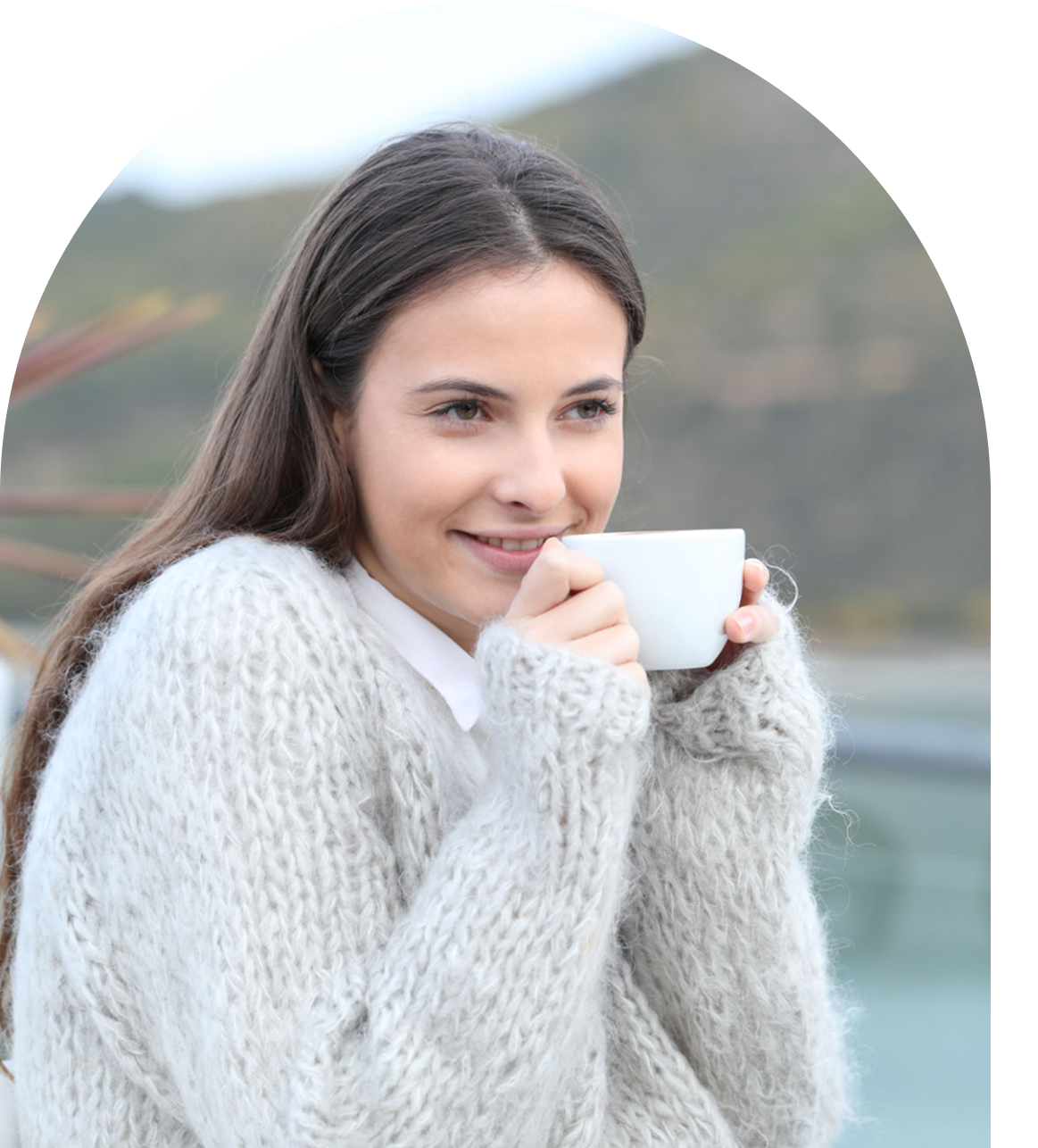 Smiling woman enjoying a warm drink