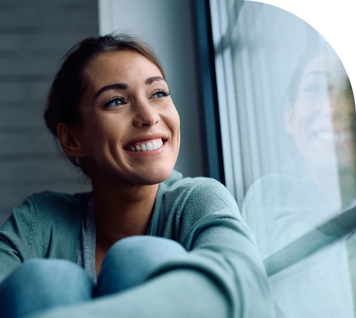 Content woman sitting by window