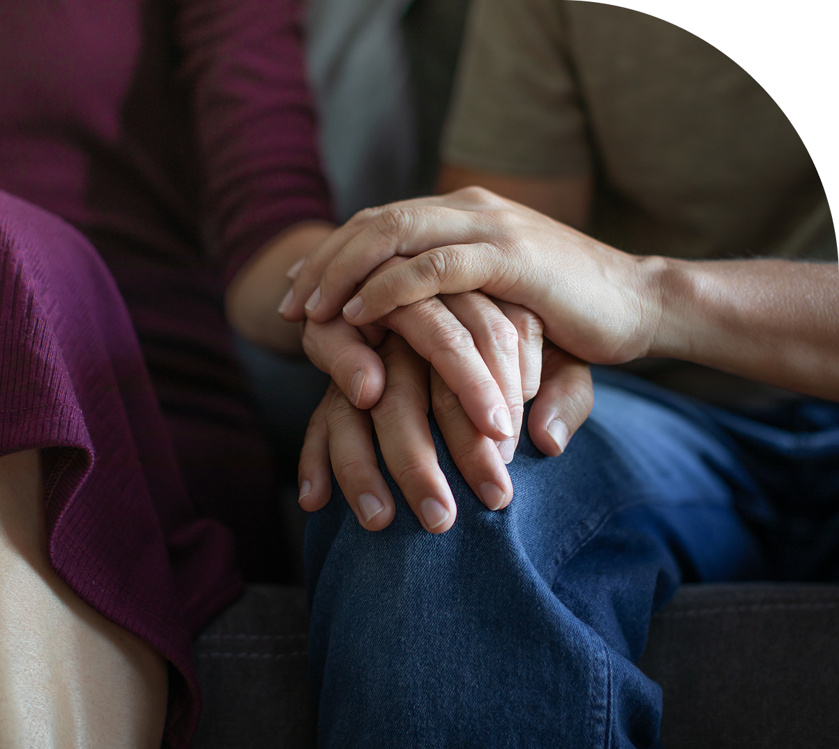 Hands resting on knees, comforting gesture